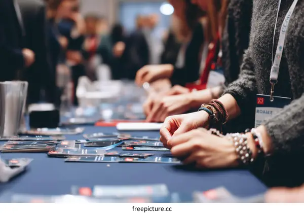 Attendees at a Business Conference Picking Up Conference Materials
