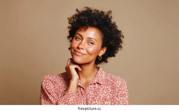 Smiling Woman with Curly Hair in Floral Shirt