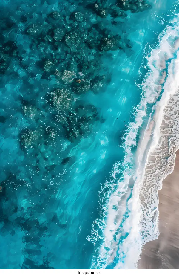 Aerial View of Ocean Waves Crashing on Sandy Beach