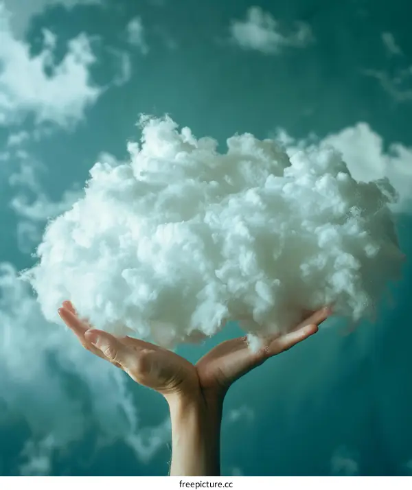 A person holding a handful of cotton clouds