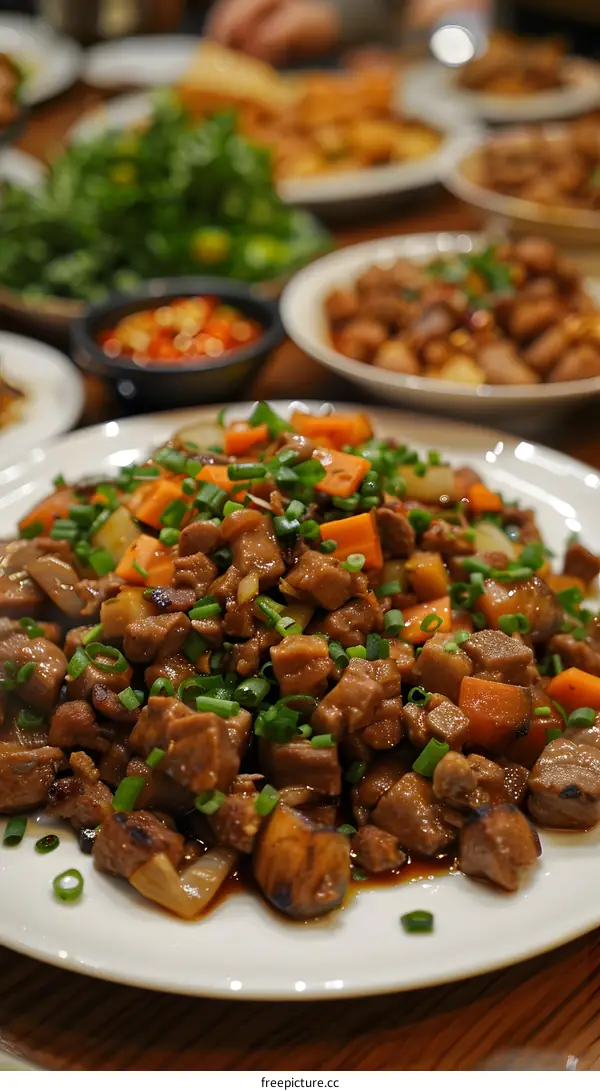 A plate of stir-fried pork with carrot and green onion