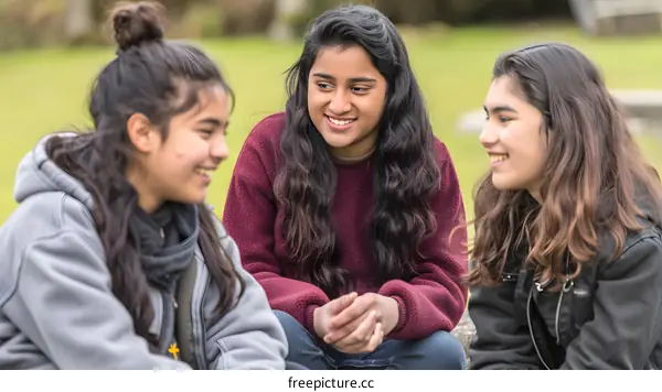 Three Friends Laughing And Talking In A Park
