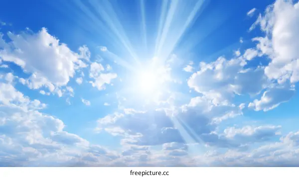 Blue sky and white clouds with sun rays shining through