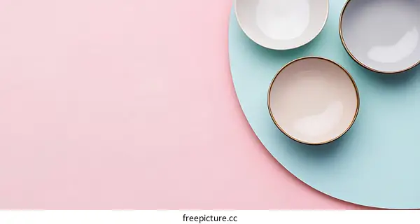 Three Empty Bowls on Pink and Blue Background