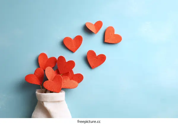 Red Heart Shaped Decorations on Light Blue Background
