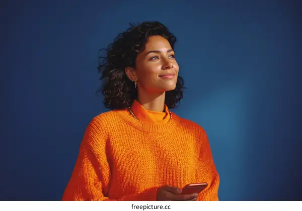 Woman in an Orange Sweater Looking Upward