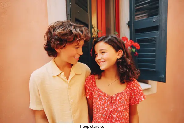 Two Children Looking at Each Other in a Colorful Town