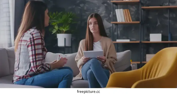 A young woman is talking to a therapist about her problems.