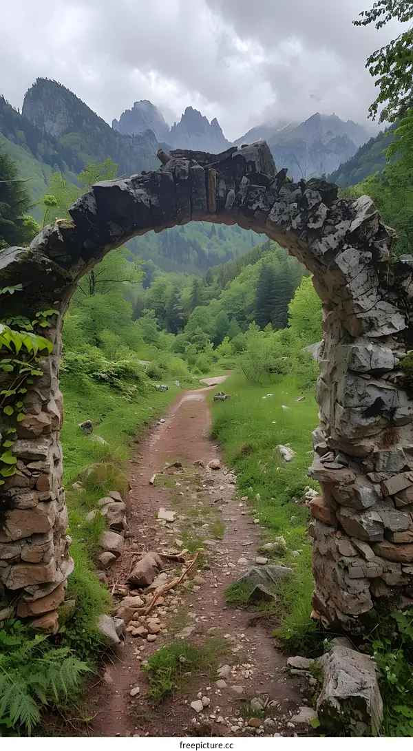Stone Archway Leading to a Path Through the Mountains
