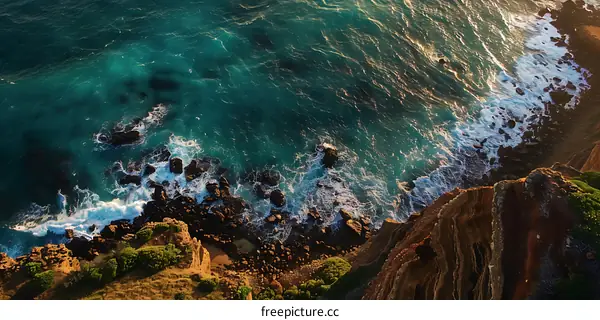 Aerial View of Ocean Waves Crashing on Rocky Coastline