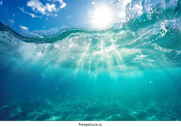 Underwater scene with sun rays shining through the water surface