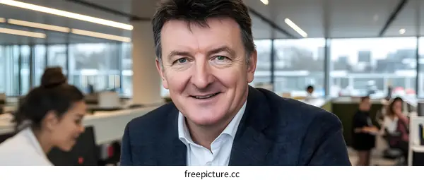 Smiling Businessman Portrait in Modern Office Setting