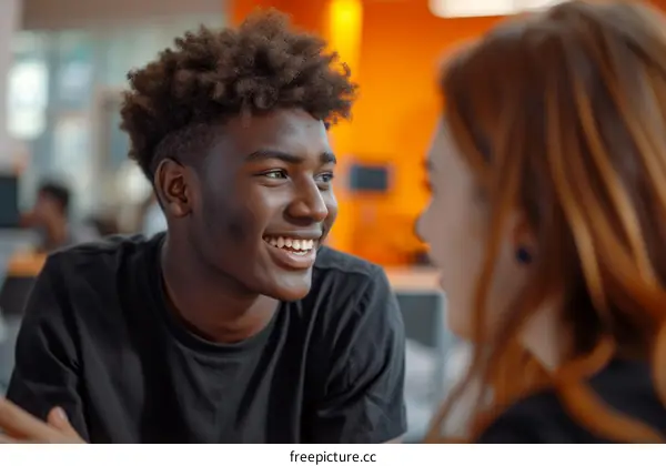 Smiling African American man talking to a woman
