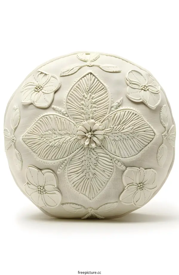 A round white pillow with 3D flower appliques