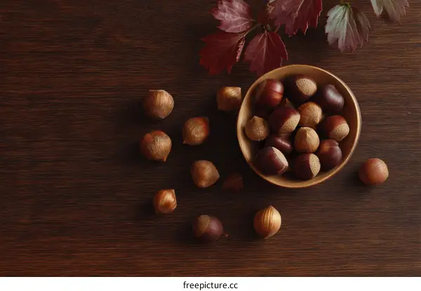 Autumn Nuts in a Wooden Bowl on Dark Wood