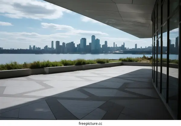 Modern terrace with city skyline view across water
