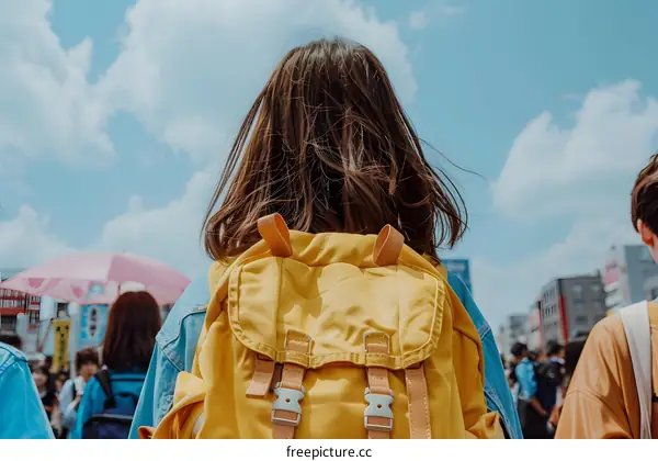Yellow Backpack Woman Walking in Crowd