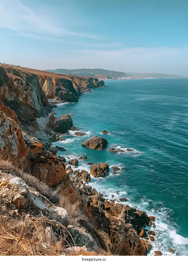 Rocky Cliffs Along the Coastline with Blue Water