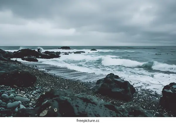 Rocky Coastline With Crashing Waves and Grey Sky