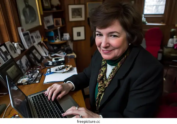 Woman in Home Office Using Laptop