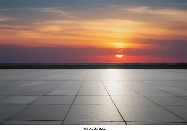 Stunning sunset over a clean tiled pavement under a colorful sky