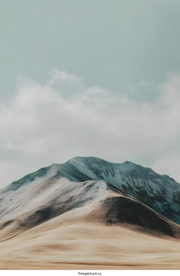 Mountain Landscape with Cloudy Sky and a Field in the Foreground