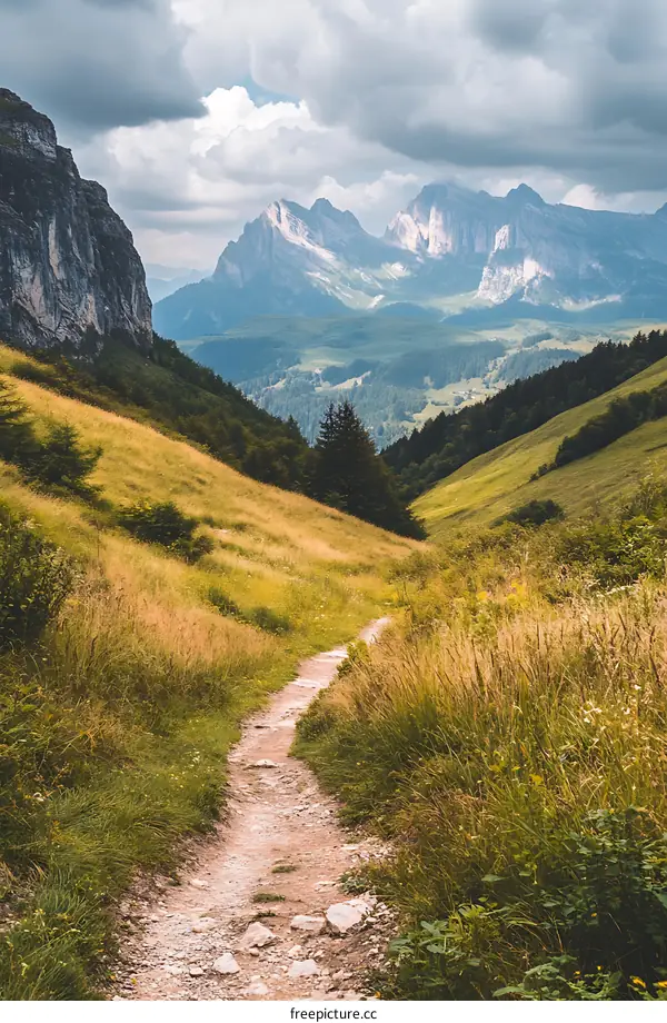 Mountain Hiking Path with View of Cloudy Sky and Peaks