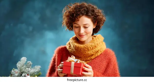 Woman Opening Christmas Gift in Cozy Sweater