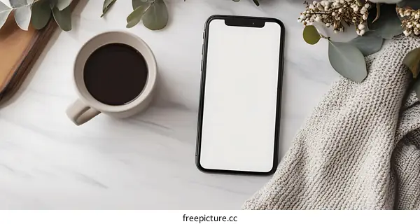 Top View of a Smartphone with Blank Screen on Marble Table