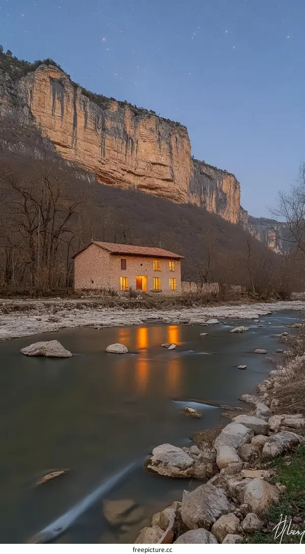 Riverside Cabin at Dusk in a Mountain Valley