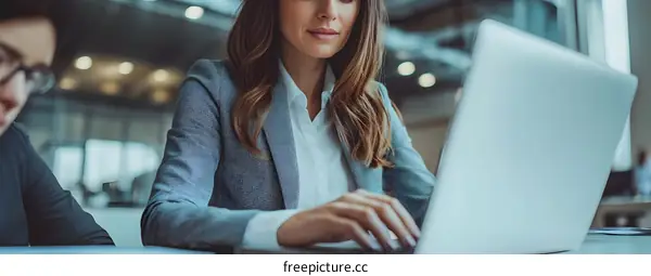 Businesswoman Working on Laptop in Modern Office