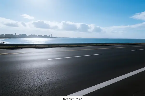Smooth asphalt road along the seaside with clear sky