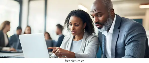Business People Working Together on Laptop in Modern Office