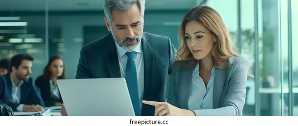 Businesspeople Working on Laptop in Modern Office