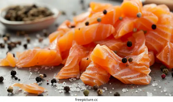 Close-up of fresh raw salmon fillet with peppercorns and salt
