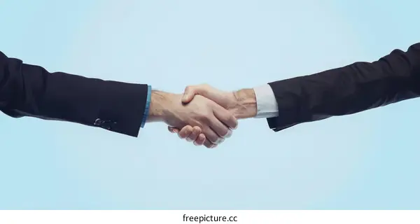Businessmen shaking hands over blue background