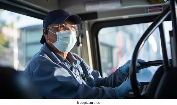 Asian bus driver wearing a mask and gloves