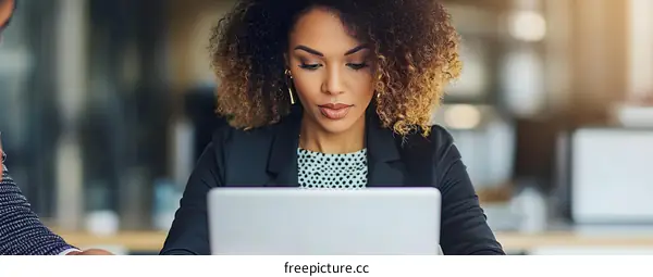 African American Businesswoman Working on Laptop in Modern Office