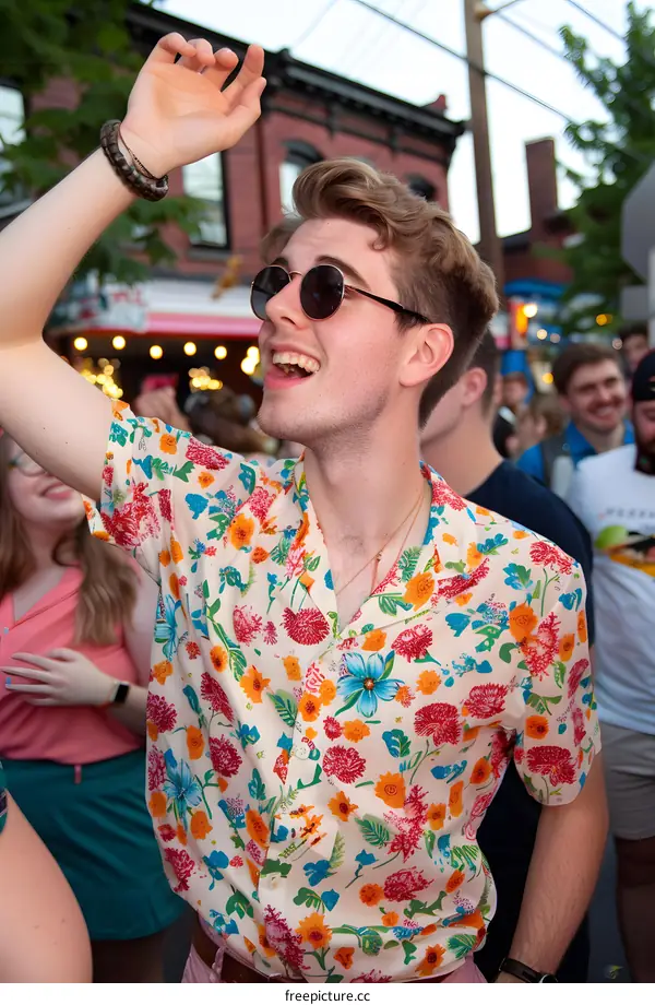 Man in Floral Shirt Smiling at a Street Festival