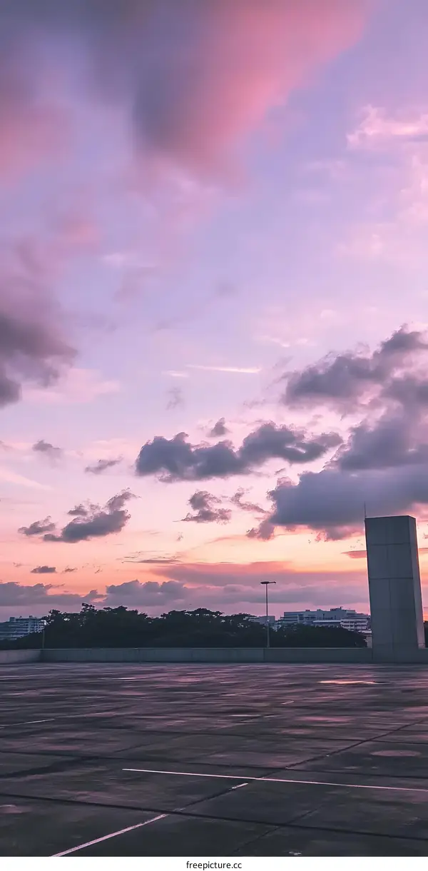 Purple Sunset Sky with Clouds over Empty Parking Lot