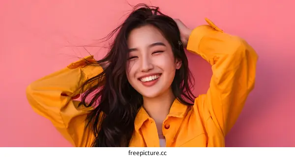 Happy Asian Woman Smiling with Wind Blowing Through Her Hair