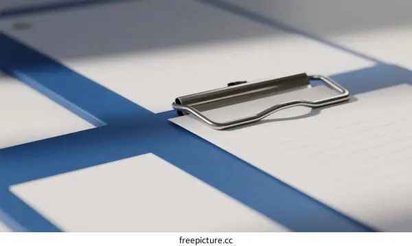 Clipboard with blank papers and metal clip for document management