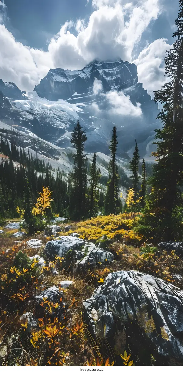 Majestic Mountain Range Covered In Snow And Clouds