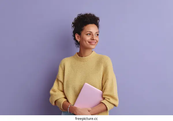 Young Woman Holding Laptop Against a Lavender Background