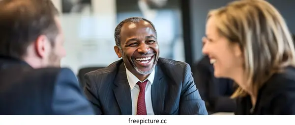Smiling Businessman  in Suit  Having a Conversation with Colleagues