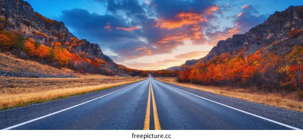 Autumn Road Trip at Sunrise through Mountainous Landscape