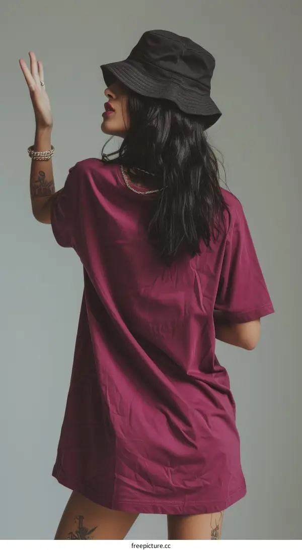 A woman wearing a bucket hat and an oversized t-shirt