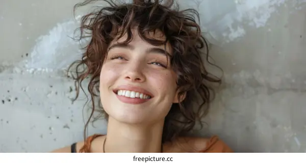 Smiling Woman Portrait on Concrete Background