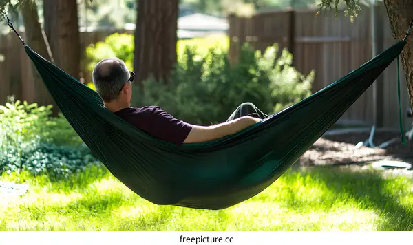 Man Relaxing in Hammock in Backyard