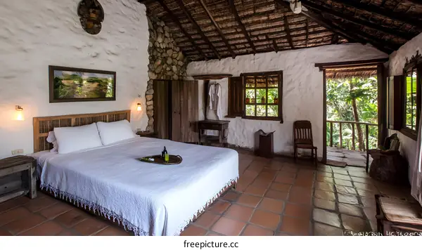 Tropical Jungle Cottage Bedroom With White Walls And Tiled Floor
